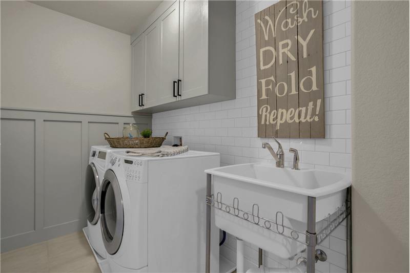 Upper Level Laundry Room with Tile Backsplash & Utility Sink