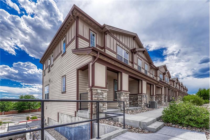 Front view of end unit townhome with covered front porch.
