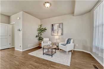 The formal Living Room has front yard views and attractive wood laminate flooring.