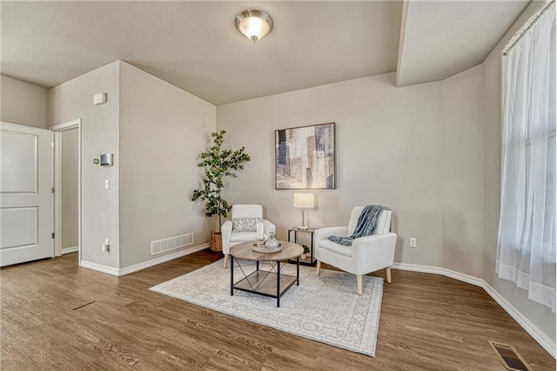 The formal Living Room has front yard views and attractive wood laminate flooring.
