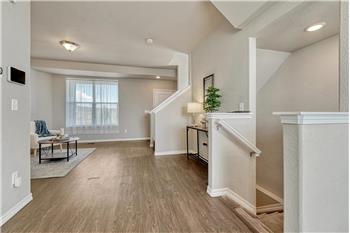 View into the formal Living Room from the Dining Area with stairs to the garage.