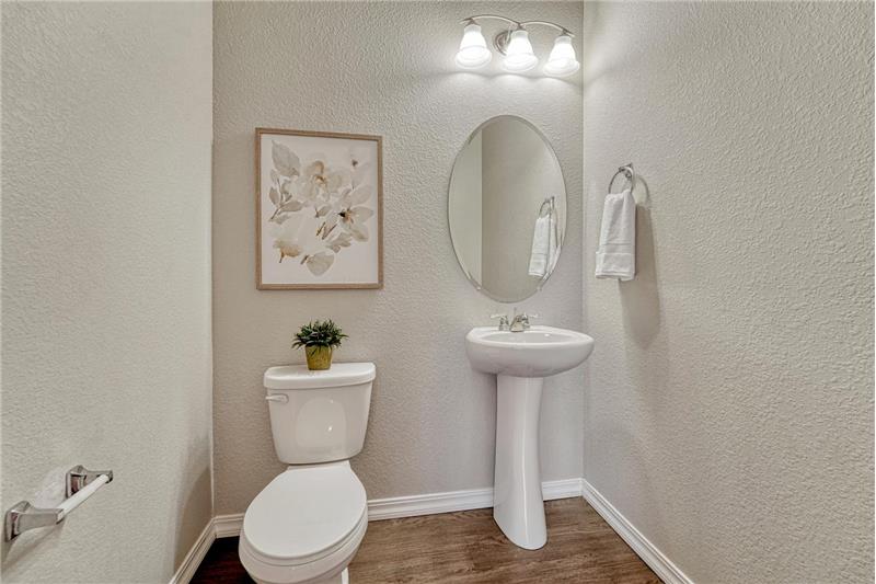 Convenient Powder Bathroom with pedestal sink.