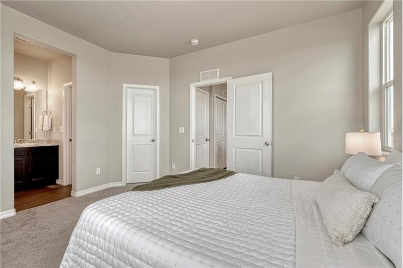 Primary Bedroom with views into the Primary Bathroom.