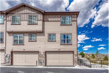Rear view of townhome with 2-car attached tandem garage.