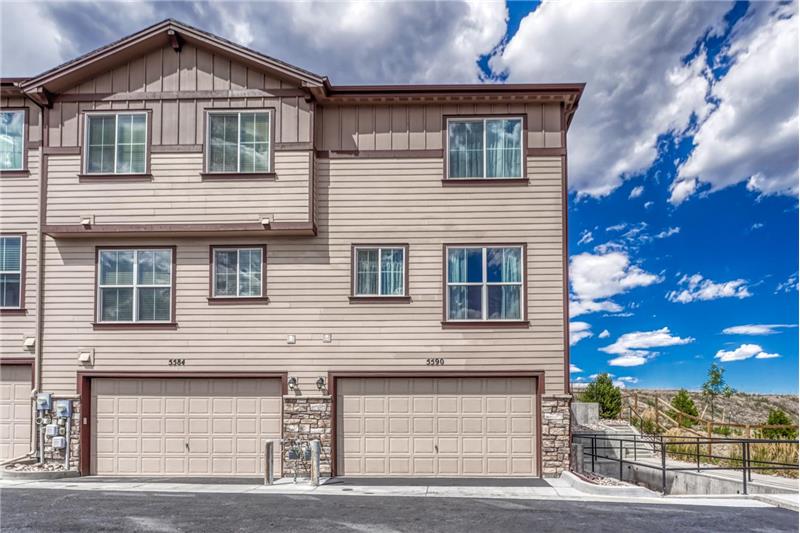 Rear view of townhome with 2-car attached tandem garage.