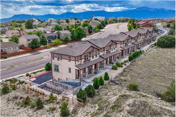 Aerial view of complex, neighborhood, and mountain views.