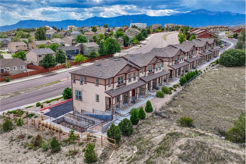 Aerial view of complex, neighborhood, and mountain views.