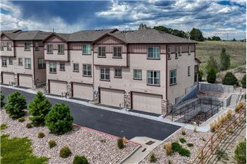 Aerial rear view of building and attached garages.