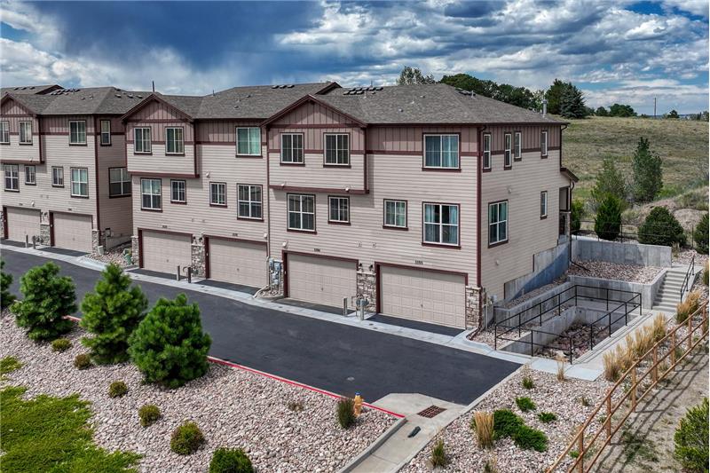 Aerial rear view of building and attached garages.