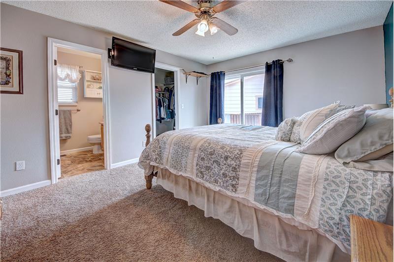 The main level Master Bedroom features neutral carpet, a walk-in closet, and an attached Full Bathroom