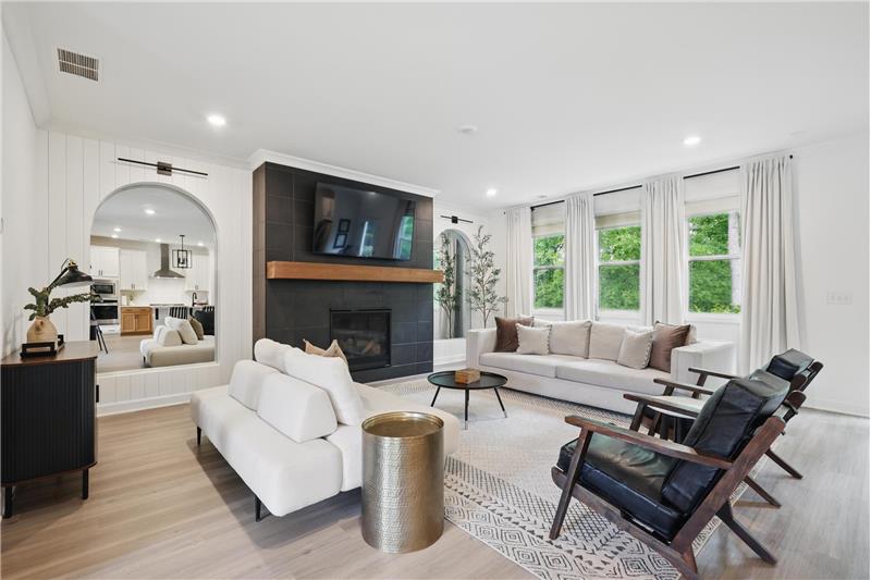 Black Matt Fireplace flanked with arched Mirrors