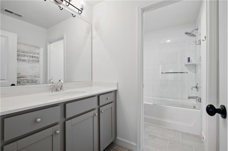 Guest bath with frameless glass door