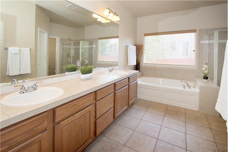 Master bathroom with double sink vanity and soaking tub