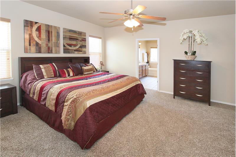 Large master bedroom with ceiling fan