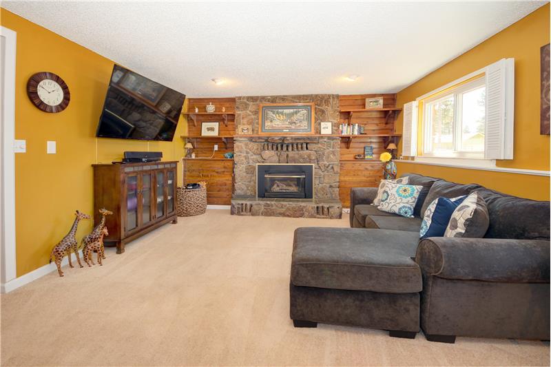 Family room with stone hearth fireplace