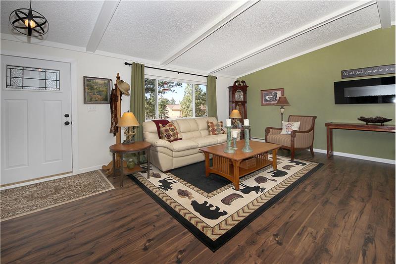 Great room with wood laminate flooring and beamed ceilings