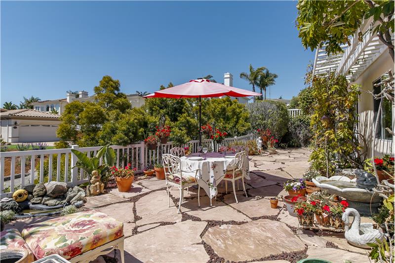 Low-maintenance white vinyl fencing, koi pond and mature landscaping.