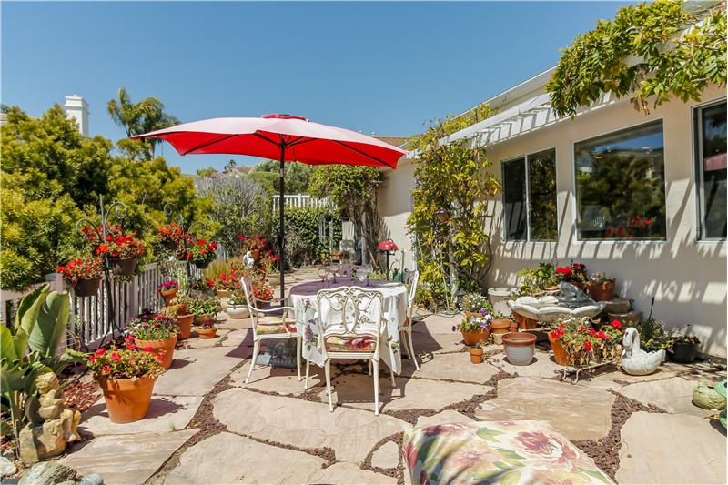 The patio outside the Primary Suite provides access to the dog run along the N/E side of home.