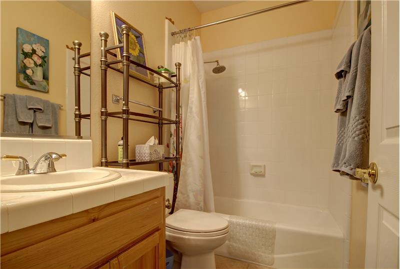 Perfectly positioned between Bedrooms 2 and 3 is the Main Bath, featured here with a tub/shower combo!