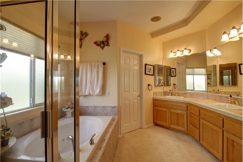 Dual sinks, tons of counter space and plenty of cabinets is the perfect segue for that Massive Walk-in Closet.