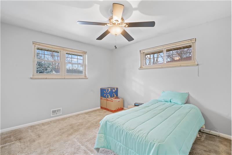 Bedroom with high windows from front and side yard
