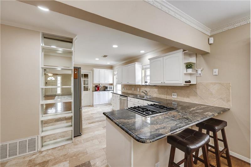 Gas cooktop, granite counters, white cabinets