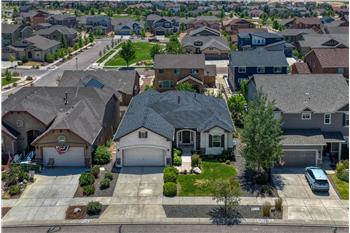 Aerial view of the front of the home and neighborhood.