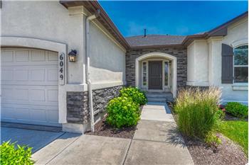 Attractive front walkway with stone accents and arched front entry.