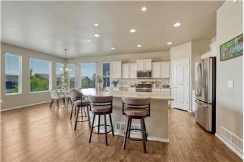 Upgraded island kitchen and dining area with wall of windows and remarkable views.