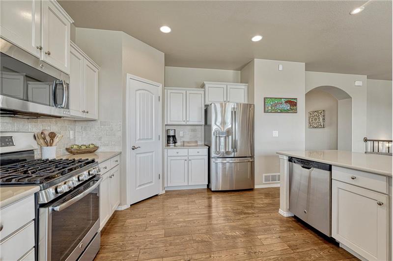 The Kitchen offers a gas range oven, microwave, dishwasher, and French door refrigerator.