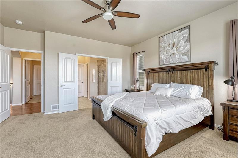 Double doors lead from the Primary Bedroom into the Primary Bathroom.