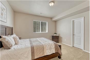 Basement Bedroom #3 has neutral carpet and a walk in closet.