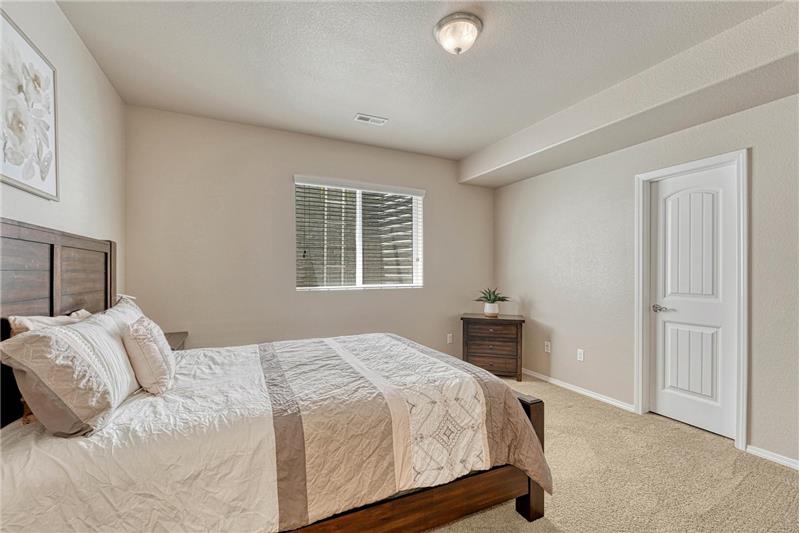 Basement Bedroom #3 has neutral carpet and a walk in closet.
