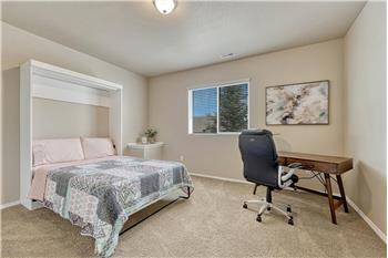 Basement Bedroom #5 has neutral carpet and space for a desk area.