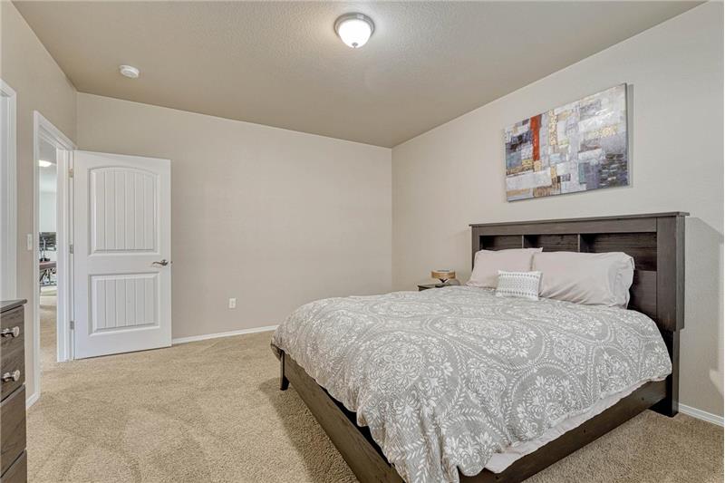 Basement Bedroom #4 has neutral carpet.