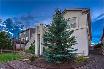 Nicely manicured yard with auto sprinklers, rock walkways, and beautiful trees and shrubs.