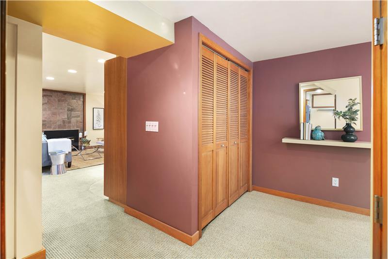 Hallway on Lower Level. Furnace and Water Heater are in the closet.