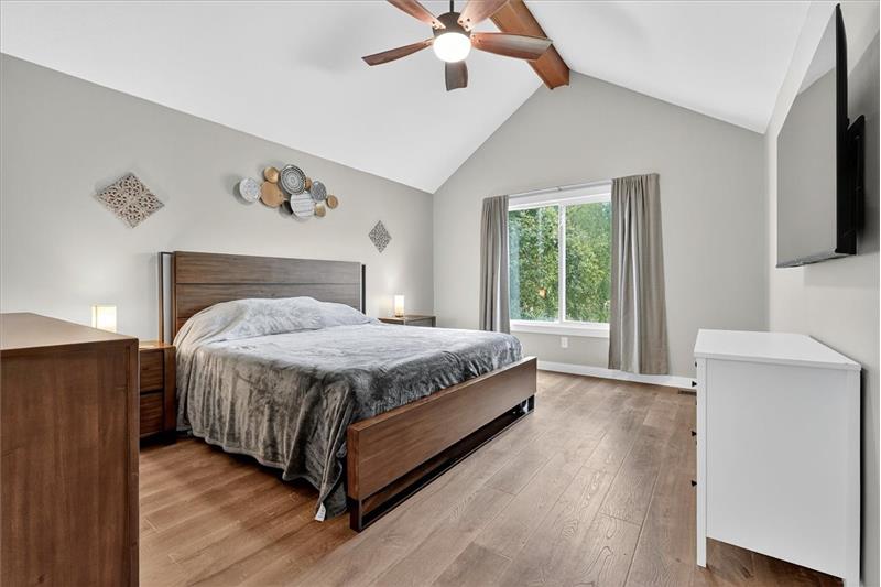 Primary bedroom with vaulted ceiling