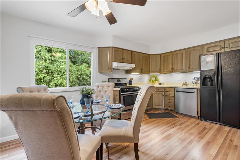 Kitchen dining w large window and ceiling fan
