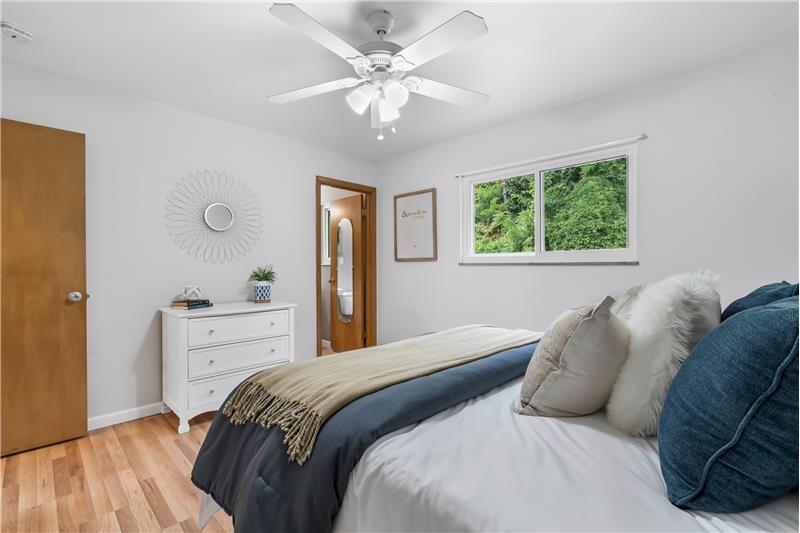 Primarybedroom looking toward 1/2 bath and large window