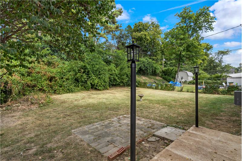  Fenced back yard with patio lights.