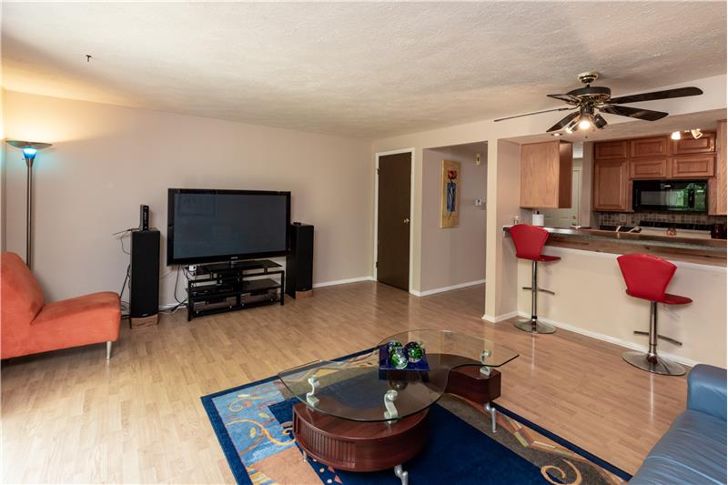 Open view of living & dining area & breakfast bar seating. - 6181 E 96th Pl