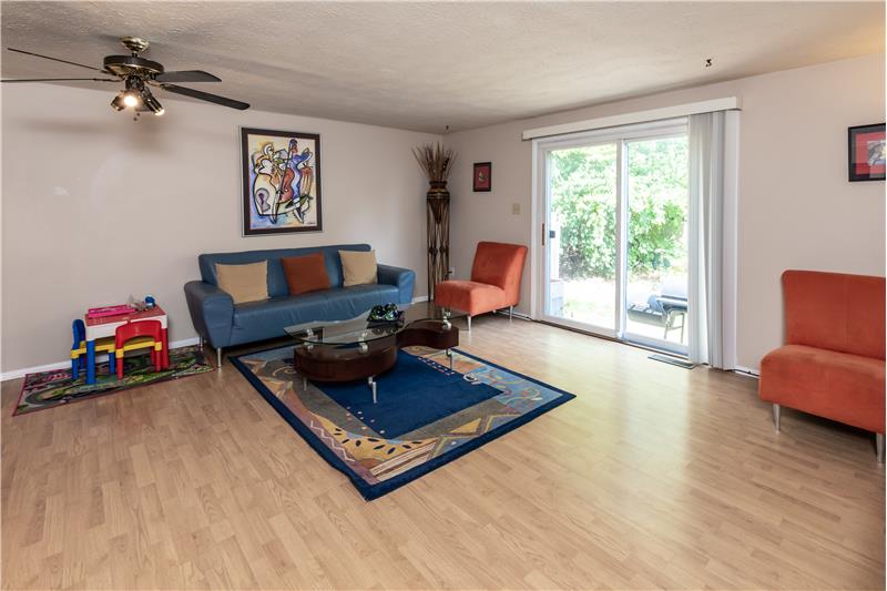 Living room open to the patio & private tree lined back. - 6181 E 96th Pl