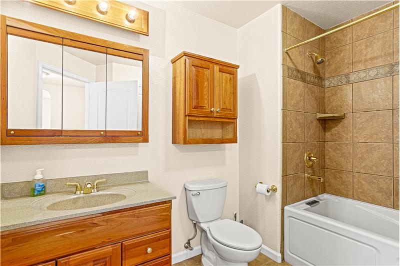Guest bathroom in hallway has jetted tub