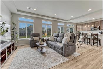 The spacious Great Room has a wall of windows (clerestory windows - builder upgrade) overlooking the backyard.