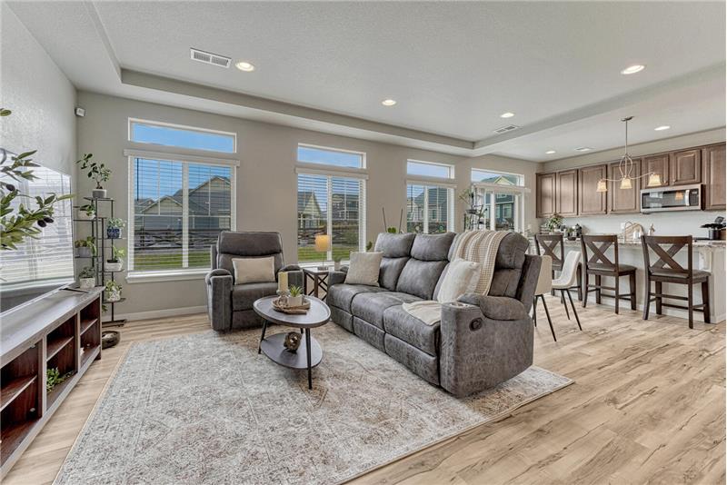 The spacious Great Room has a wall of windows (clerestory windows - builder upgrade) overlooking the backyard.