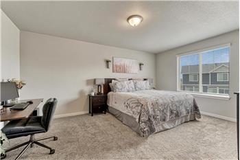 The expansive Primary Suite serves as a private retreat with space for a sitting or desk area, a walk-in closet, & Ensuite Bath.