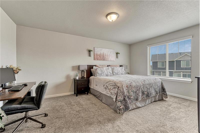 The expansive Primary Suite serves as a private retreat with space for a sitting or desk area, a walk-in closet, & Ensuite Bath.