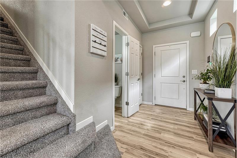 Front Entry with LVP flooring and stairs to the upper level.