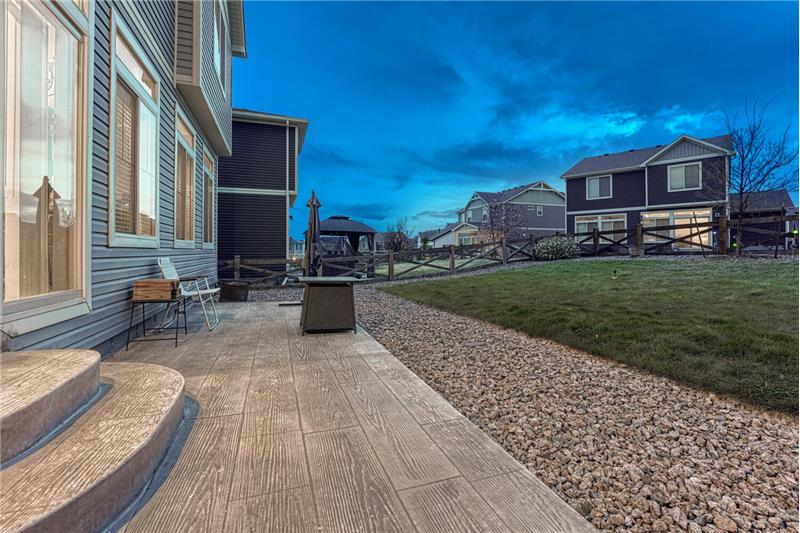 Sunset view of composite patio and backyard.